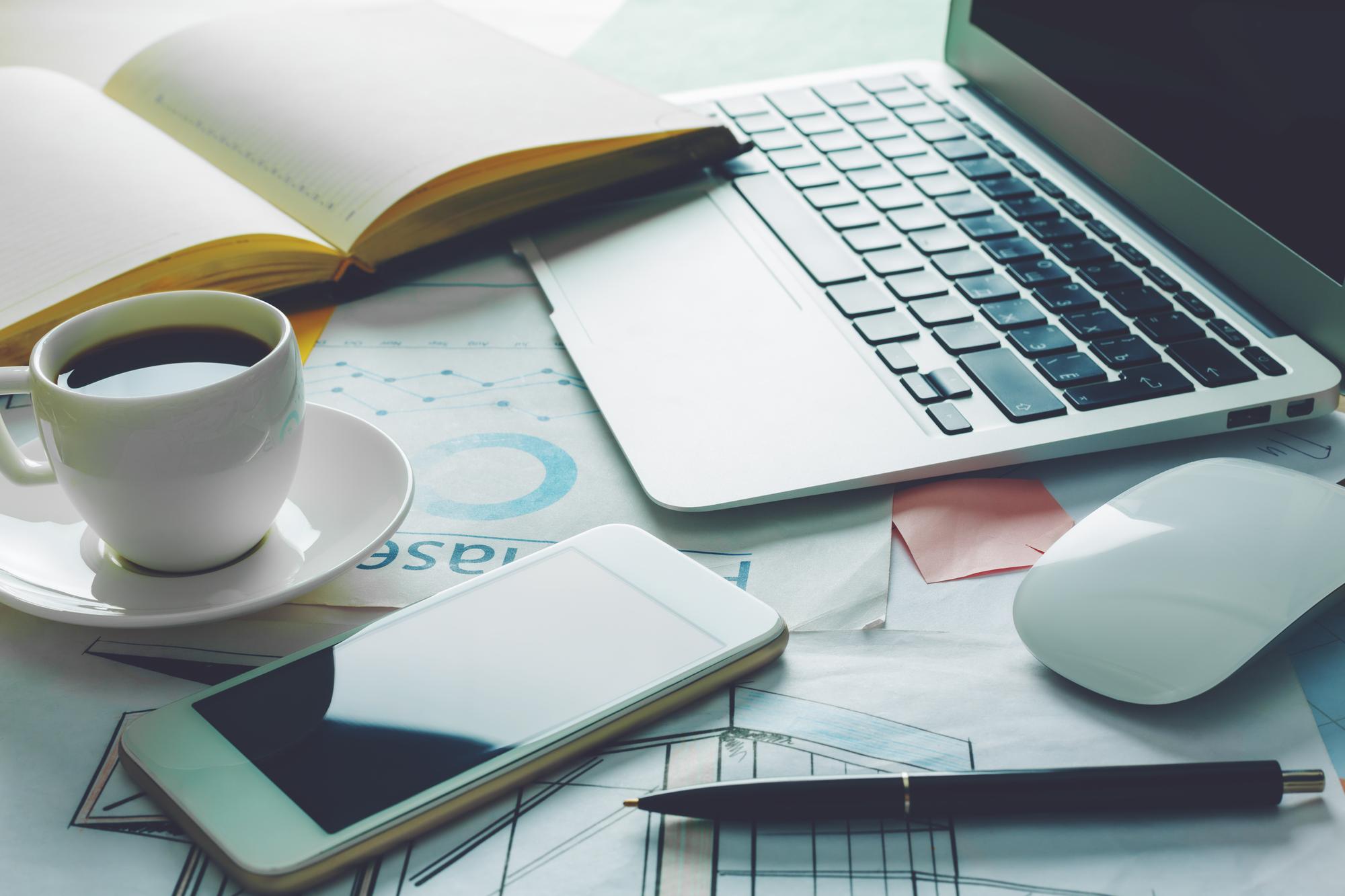 Workspace with financial notes and laptop